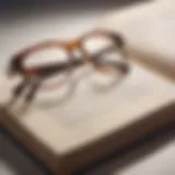 Stylish clear glasses with tortoiseshell rims on a vintage book